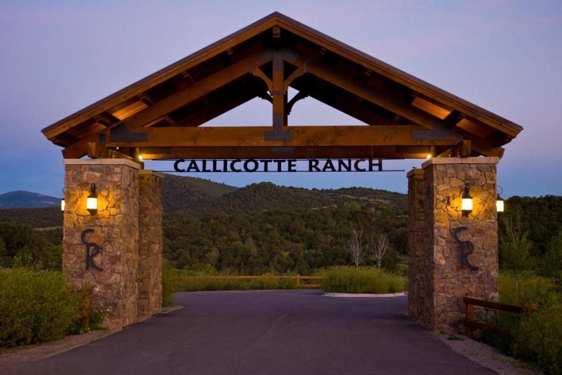 Entrance to Callicotte Ranch, Carbondale CO. Grand rustic entrance with mountains visible through the entryway.